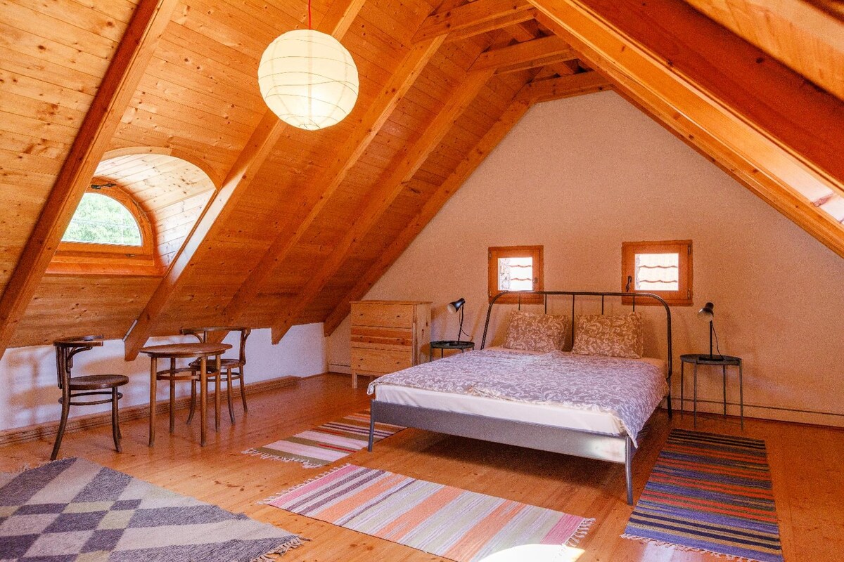 The loft bedroom is bright, spacious, comfortable, slightly more modern. 
This is  the hottest room in winter.

Dormitory in the attick: a bit more modern than the downstairs part of the house. This is the warmest room in winter.
