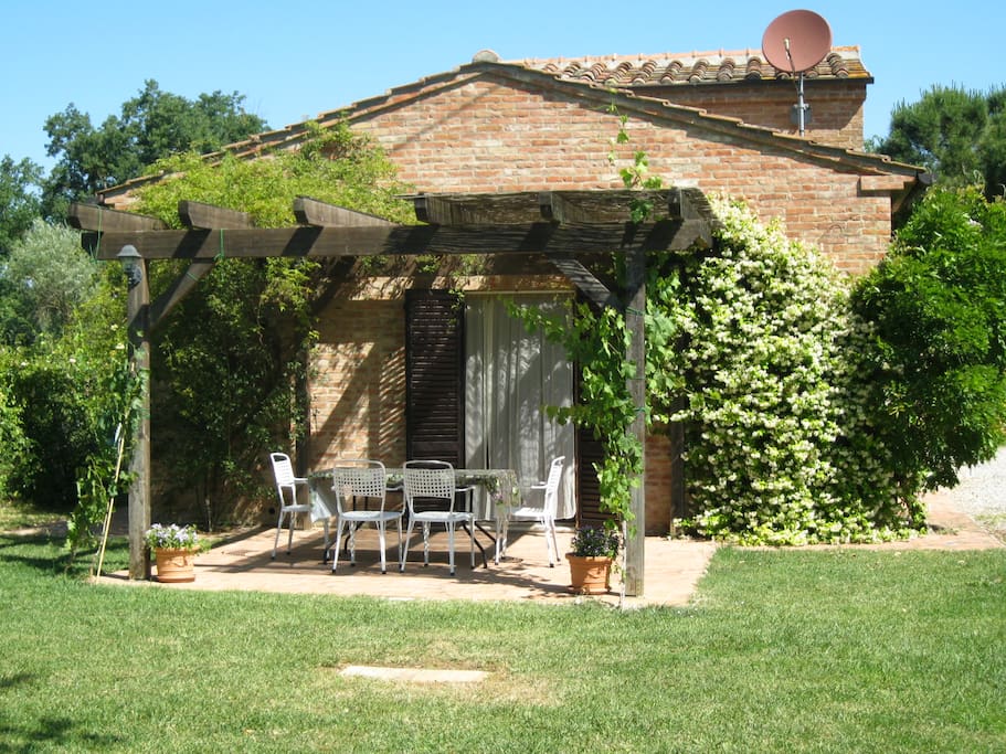 patio and pergola in front of cottage