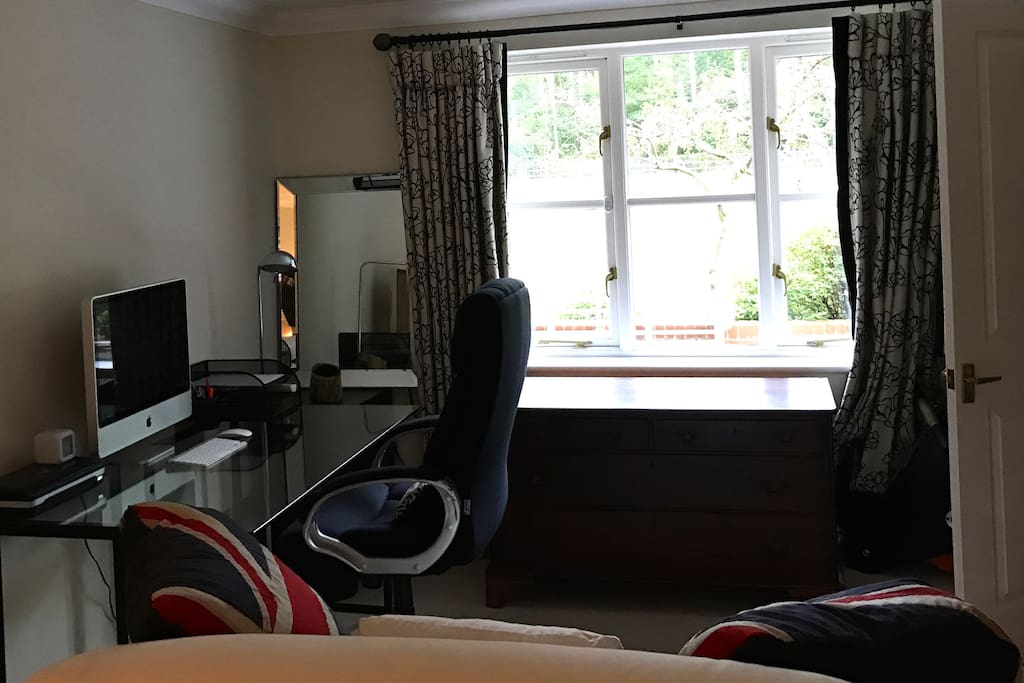 Showing Desk and Mac Computer available to use as well as view out onto the garden
