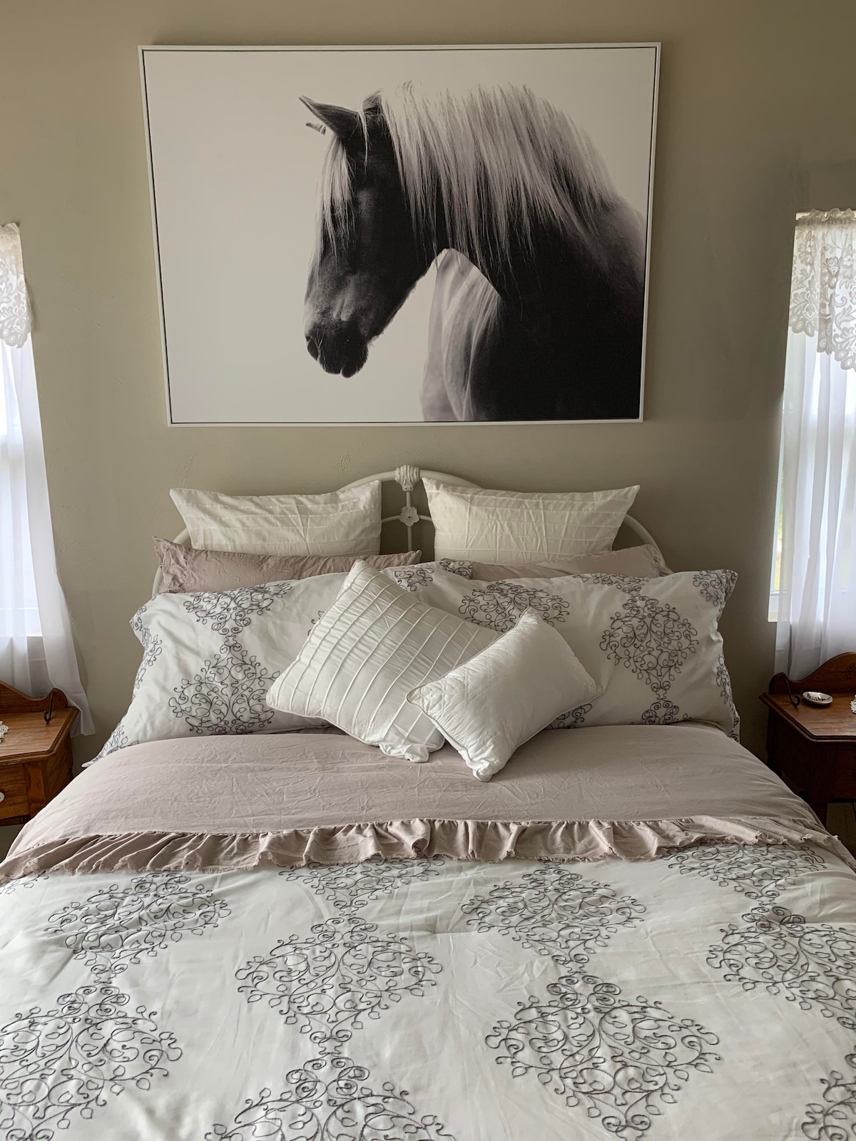 Luxury master suite with farmhouse accents and inviting plush queen bed for a quiet restful nights sleep.