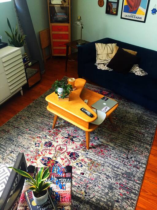 Open living room with vaulted ceilings, exposed beams. (View of living space/great room from loft)