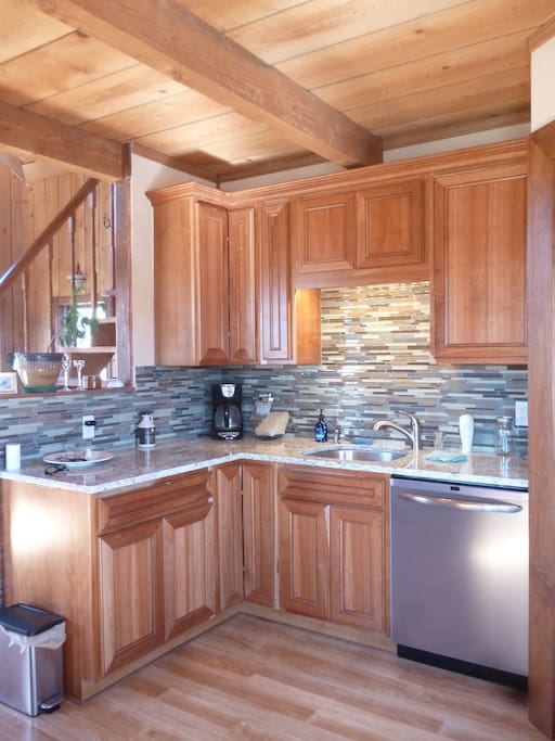 Renovated kitchen with granite counter tops, stone tile back splash and new stainless steel dishwasher.