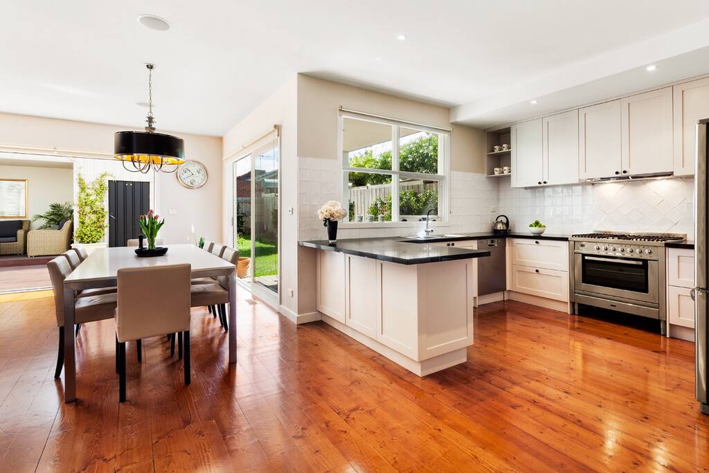Cooks dream kitchen with 6 burner Ilve oven and double fridge leading straight to indoor and outdoor dining areas.
