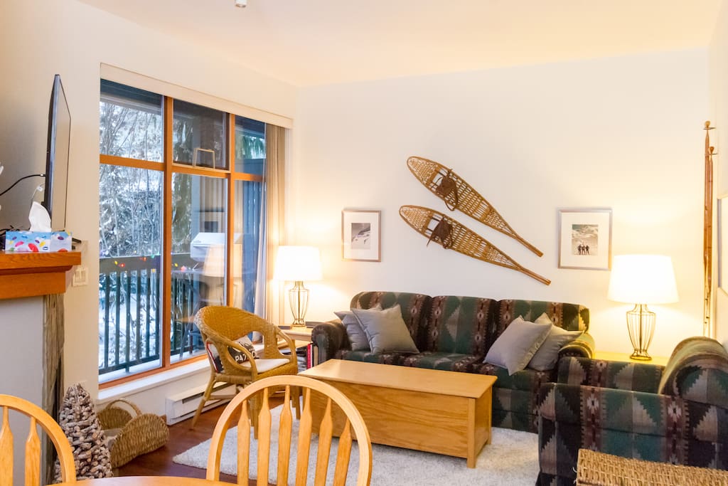 Living room with pull-out couch, fireplace, games, toy box, and views of Whistler