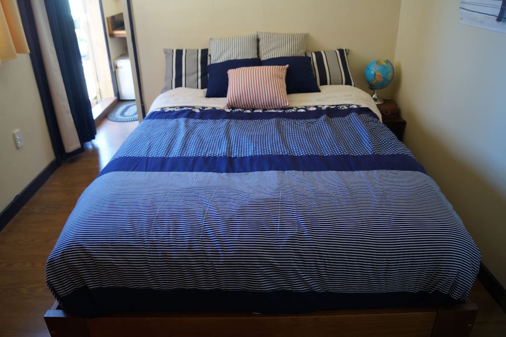 Bedroom with one queen size bed with fresh quality sheeting down duvet and hotel quality towels