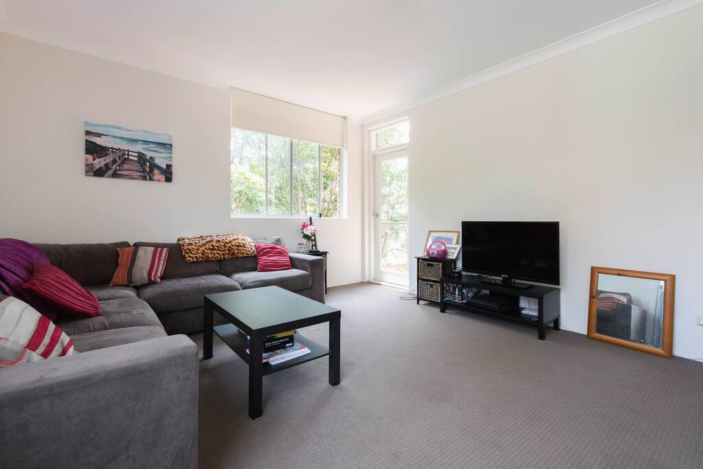 Another angle of living room. TV and the door, which leads to balcony