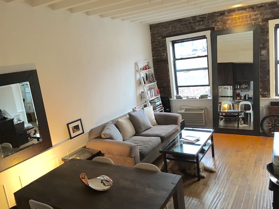 Spacious well lit living room with one kitchen