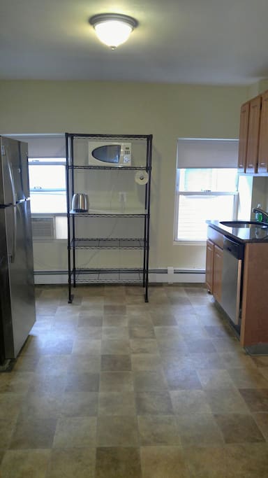 Kitchen equipped with refrigerator, stove, oven, microwave, dishwasher etc.