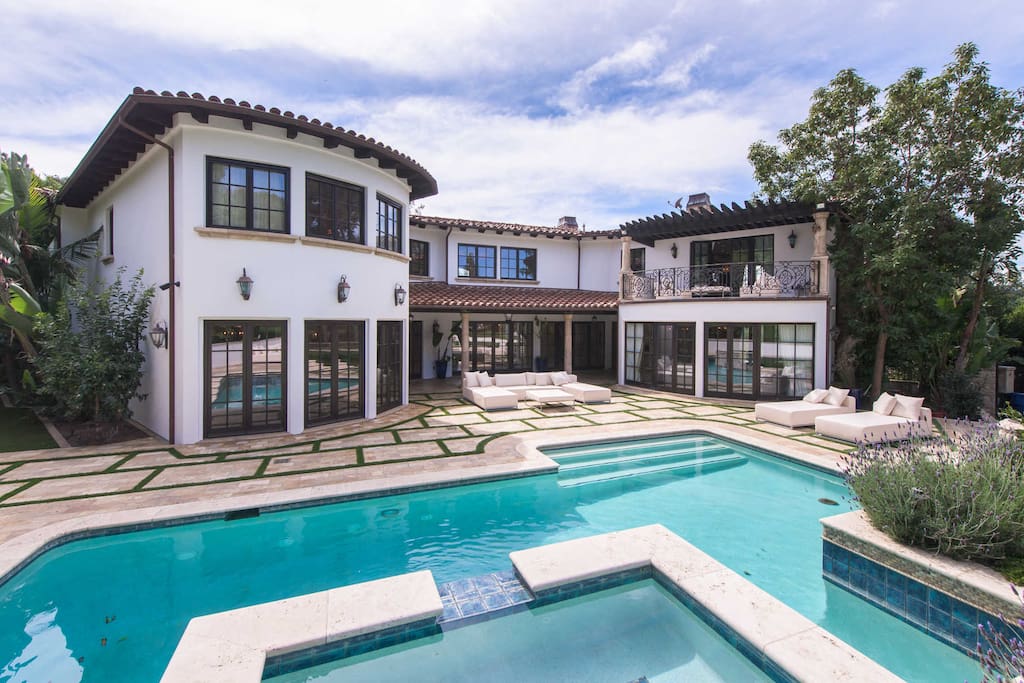 Backyard and pool. You can see the modern white lounge chairs and resting area. Also, you can see the balcony from the master bedroom.