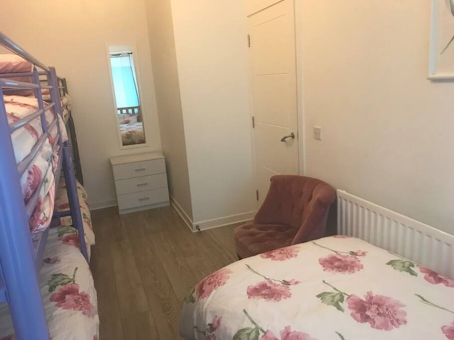 Clean and cosy bedroom for 5 with large window, full length mirror, side table and chest of drawers