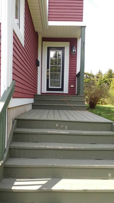 The main entrance is tucked around the corner from the driveway.
