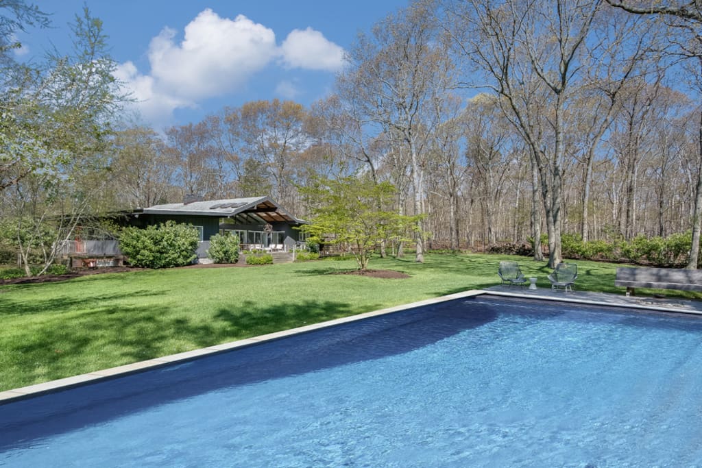 pool with lounge seating and fire pit
