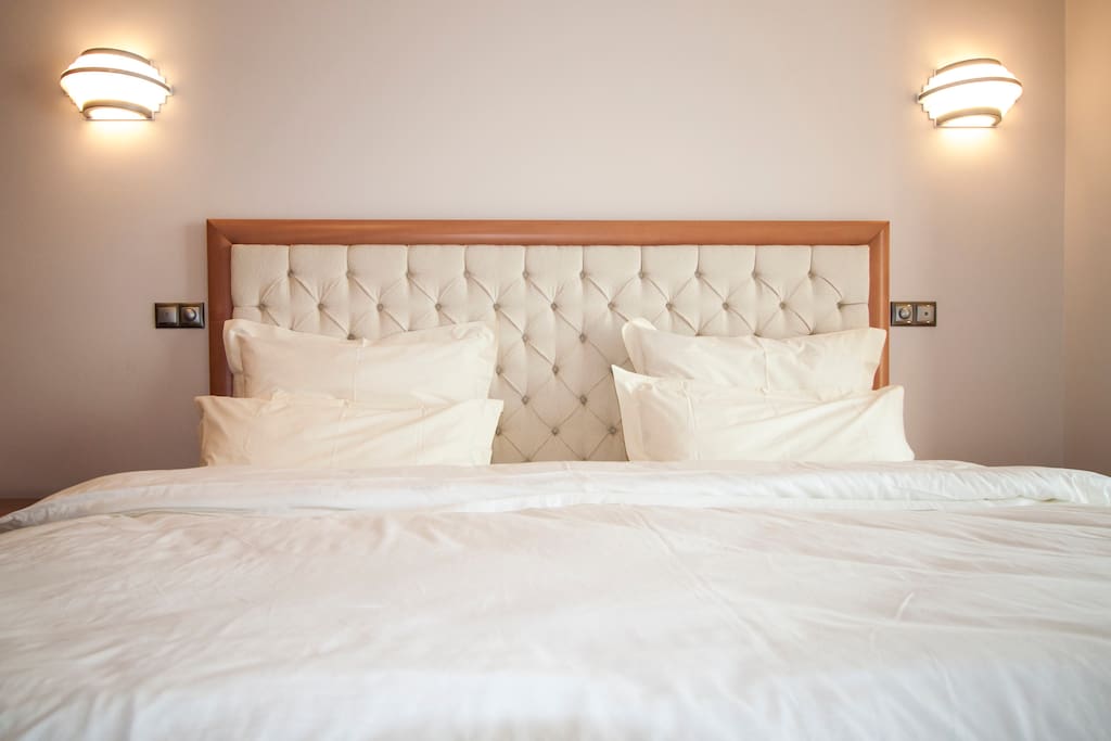 (Bedroom). King size bed, 2m x 2m, framed by adjustable intesity bed-lights.