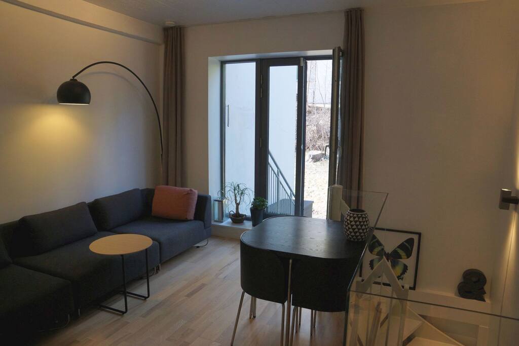 Modern clean lounge living room with access to garden and 25m2 outdoor private deck.
