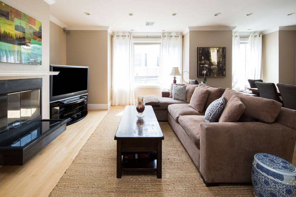 Living room has flatscreen TV and cozy, working fireplace