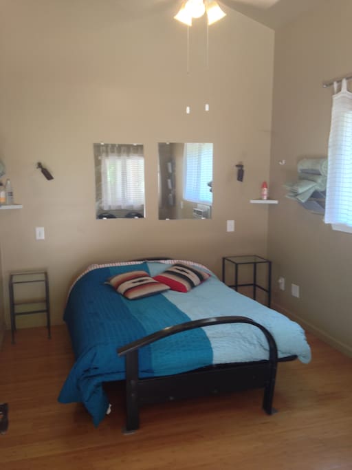 Interior: full size bed, side tables, mirrors, 2 folding chairs, cross-flow ventilation, ceiling fan, A/C, heater.