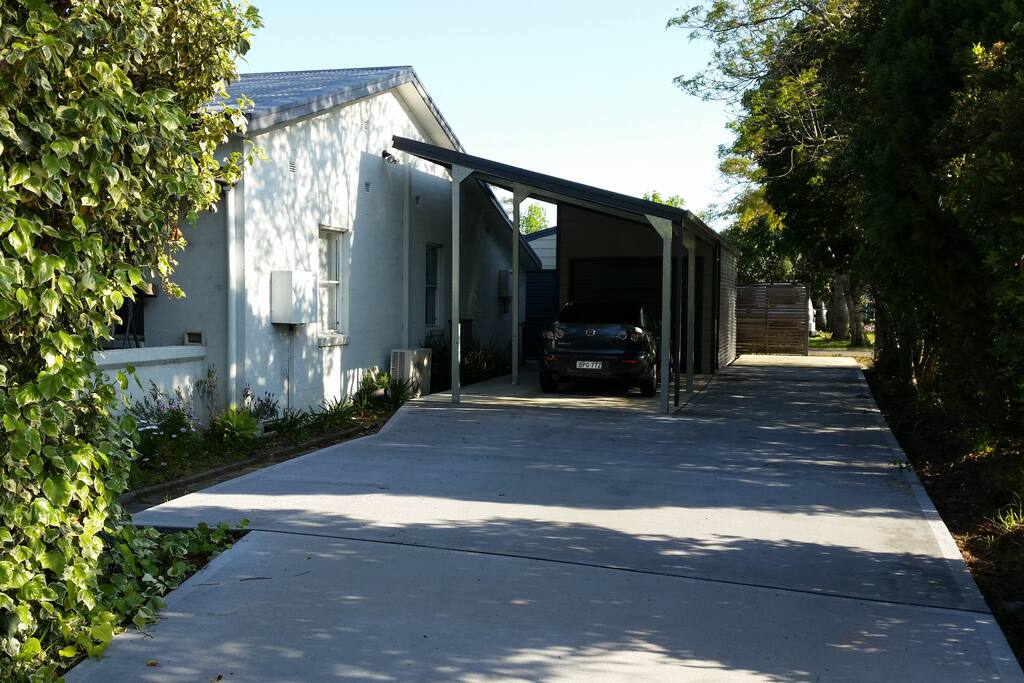 Undercover car port with enough additional parking space for 4 cars.