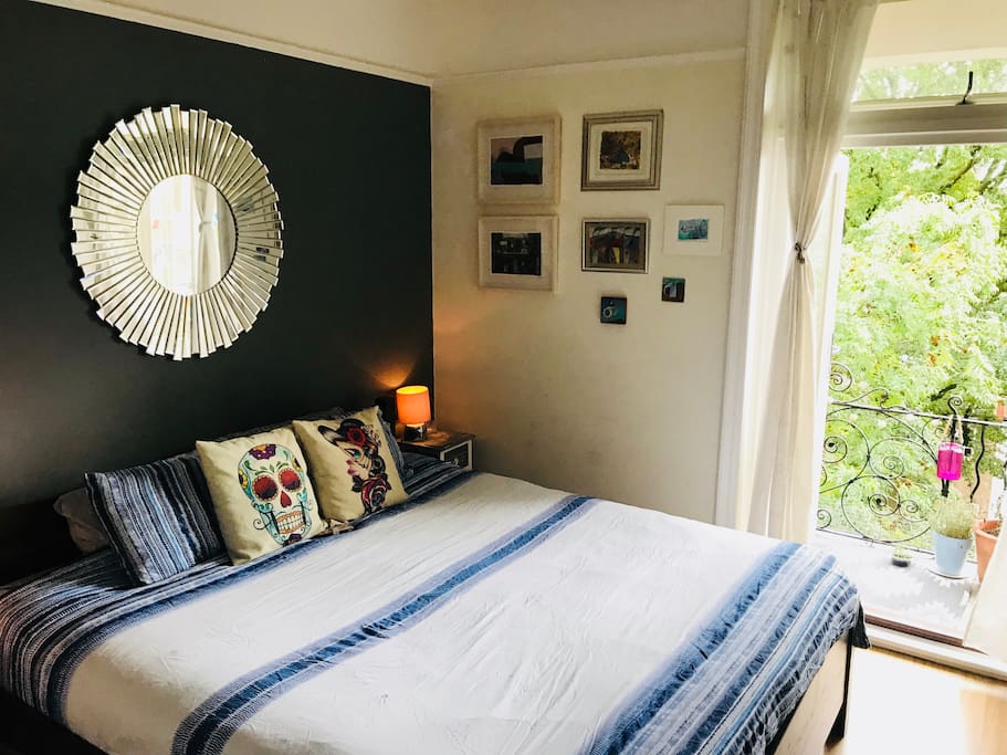 King size bed opens out onto balcony via beautiful french doors