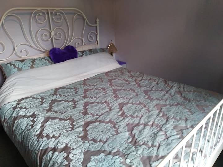 The comfy bed in the front bedroom