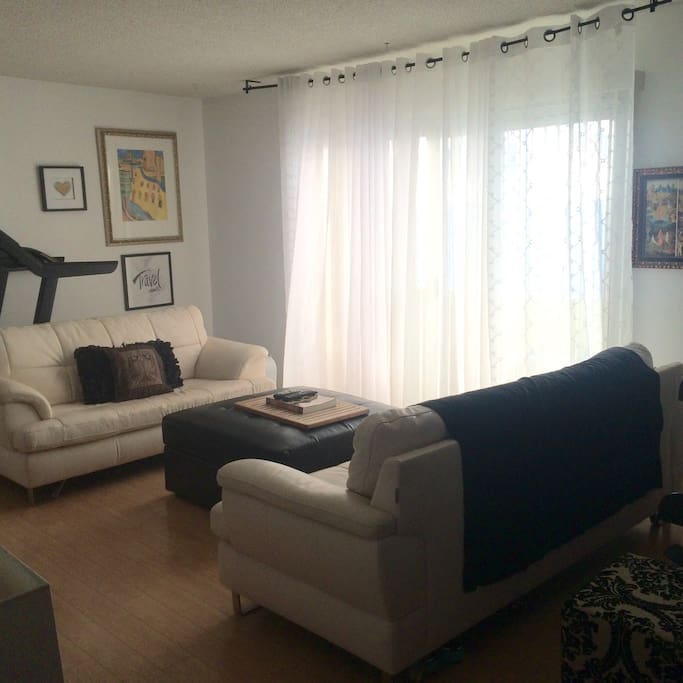 Control your lighting with curtains and blinds. There is a private patio beyond the curtain with a grill.