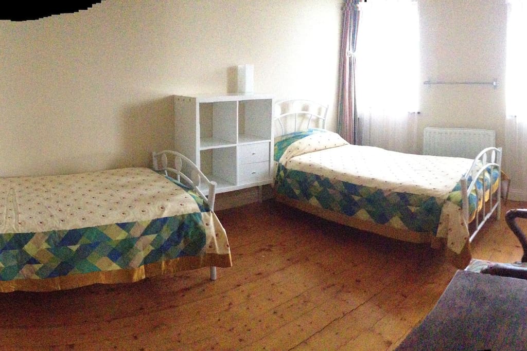 Another view of the twin room, showing storage and general space.