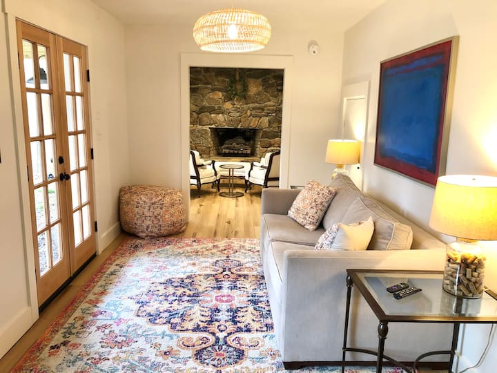 Ground level den with large windows and door to exterior 