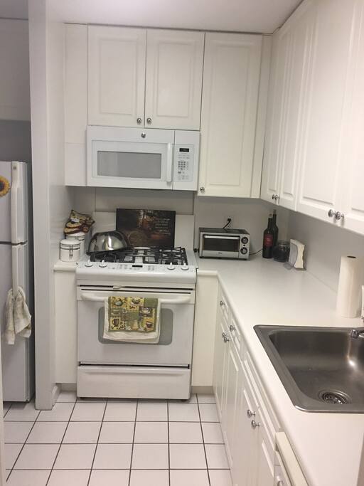 Small kitchen, oven, microwave, toaster, dishwasher, Bullet blender, Soda Stream, Italian Espresso stove-top coffee pot.