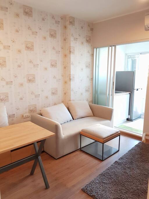 Cozy living room with fitted dining table and sofa. After a long day of working or travelling, you can rest here.