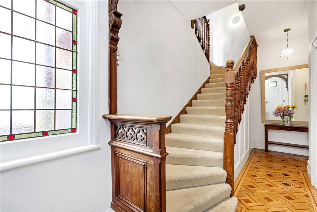 Entrance Hall with original victorian mahogany staircase, parquet and stained glass window