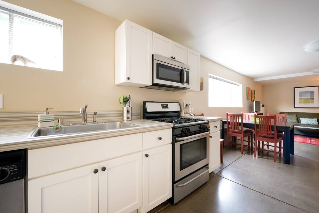 Partial view of main room from kitchen area. Polished concrete floors throughout the entire suite giving it a modern and clean look.