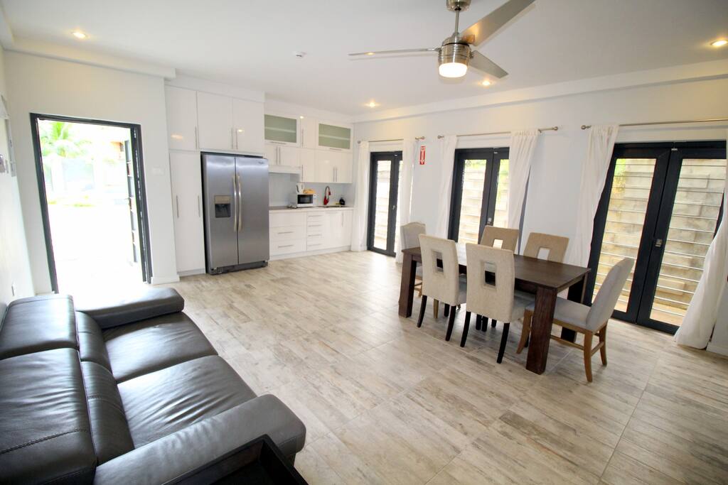 Enter into the cozy living / dining / kitchen area. Doors on the far side can be opened for an airy feeling throughout.