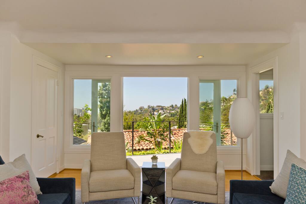 Sun filled living area with deck, views, wet bar, and 1/2 bath