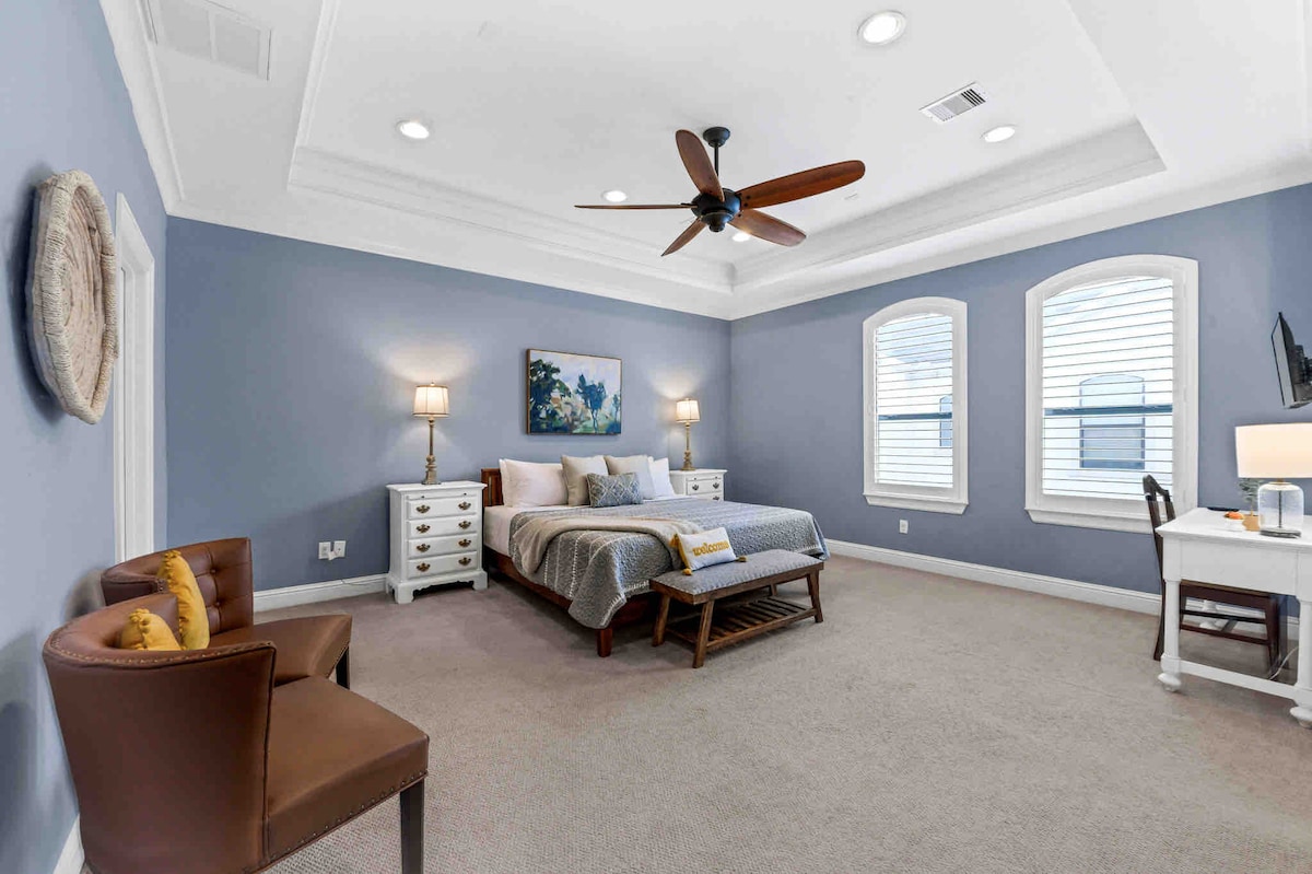 Master Bedroom with king bed and two fold away twin beds in the closet with covers and pillow.