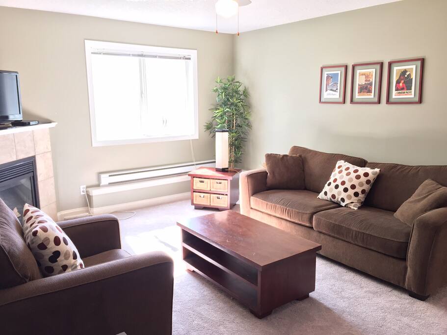 Comfortable couch and chair, and new soft carpet.