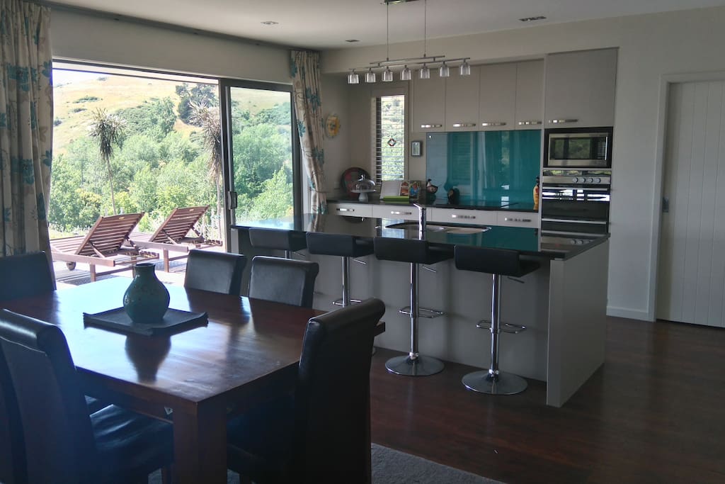Kitchen and dining area with huge opening doors to deck.