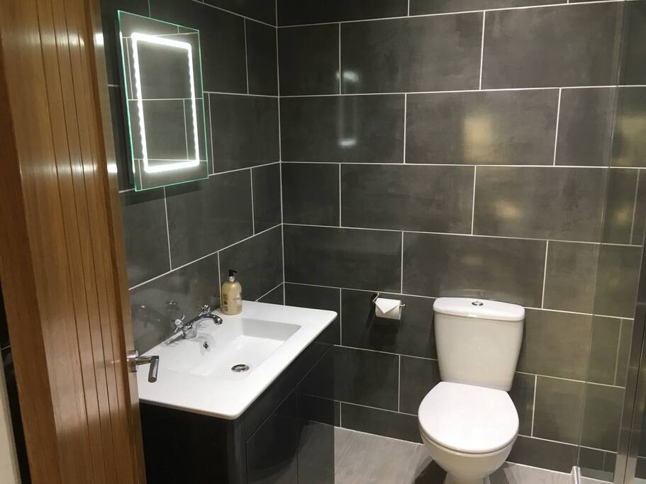 A lovely bathroom with electric shower, heated towel rail and fluffy towels.