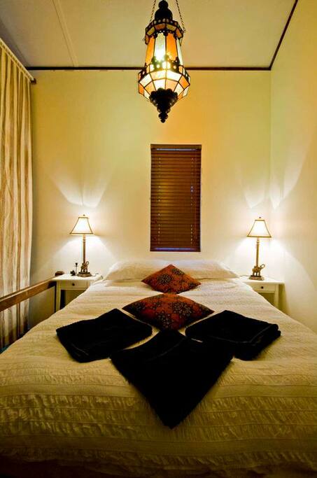 2nd double bed up on the "stage". Separated by ceiling high heavy curtains