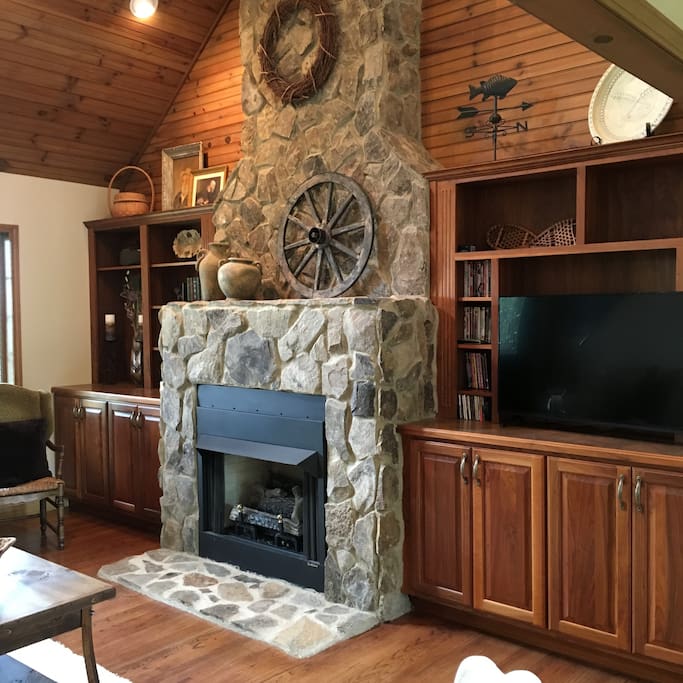 Stone fireplace with bookcases and flat screen tv.