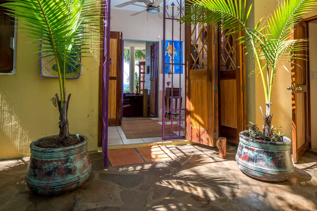 Front door looking through hall and living room to water.