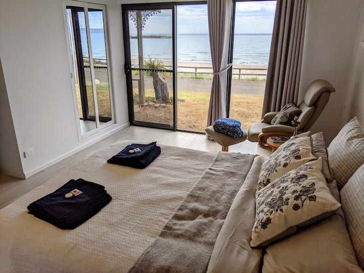 Master bedroom with queen sized bed and views of the bay.