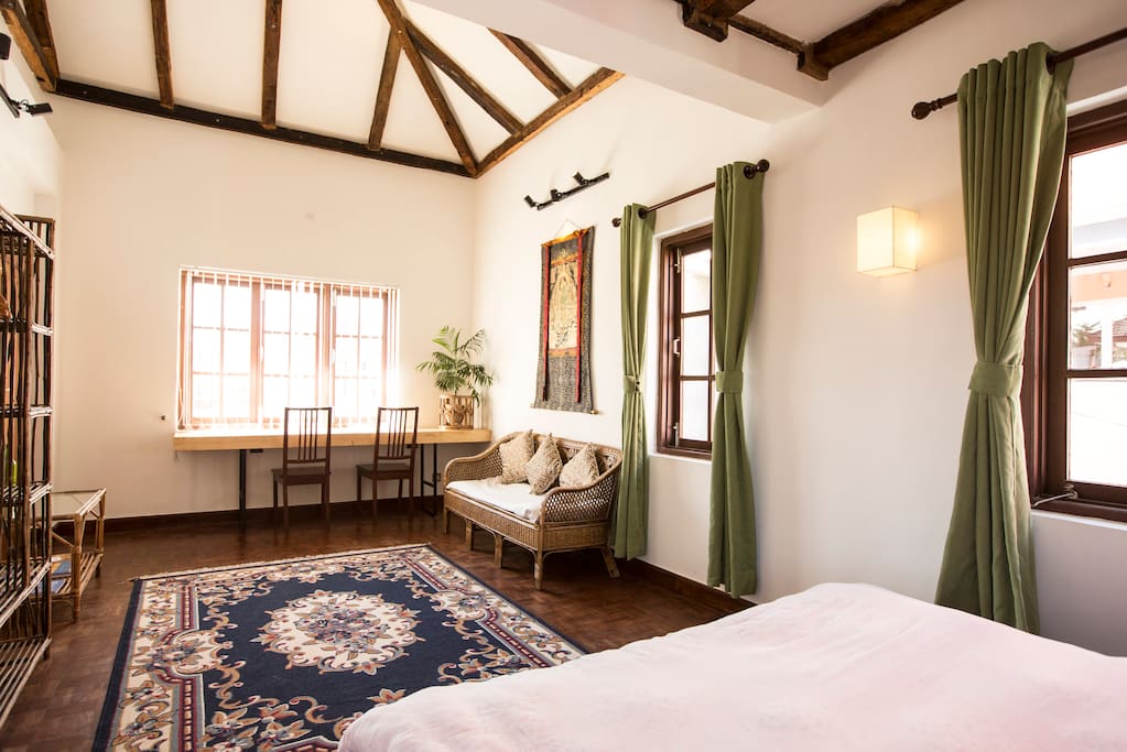 Another view of the same room. Feel home with wooden floor and high ceiling remodeled using recovered wood.