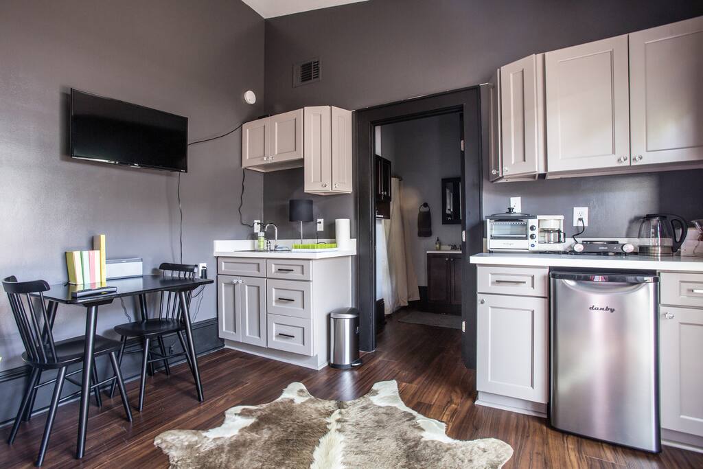 Sink, TV (cable), small refrigerator, hot plate, table for two, multiple coffee maker options, toaster oven, etc..,
