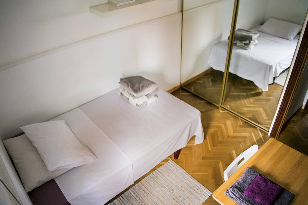 The room is well illuminated, and has a cool view of the street. Behind the mirror is your 2 door closet.