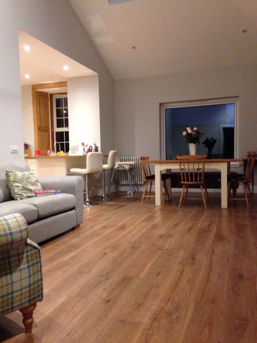 Spacious living/dining area at rear of house, with doors to garden