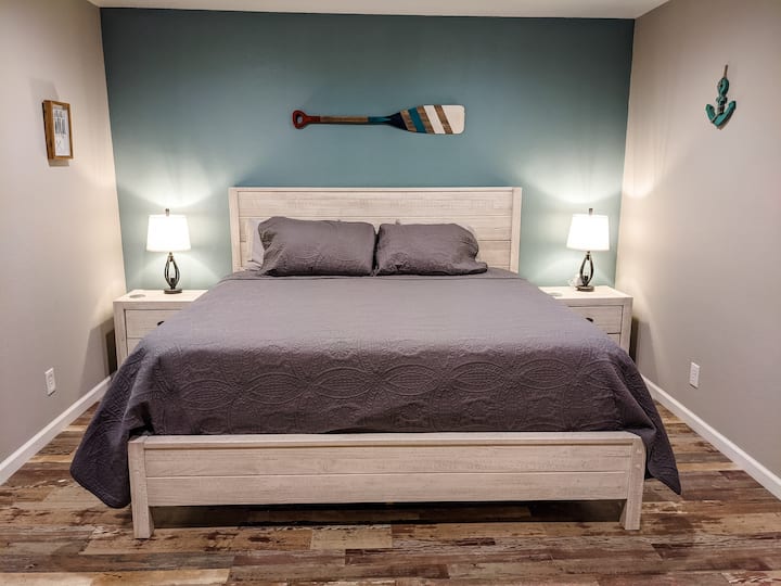 Master bedroom with a king medium-firmness memory foam mattress, lamps with USB connections, and a white noise machine.