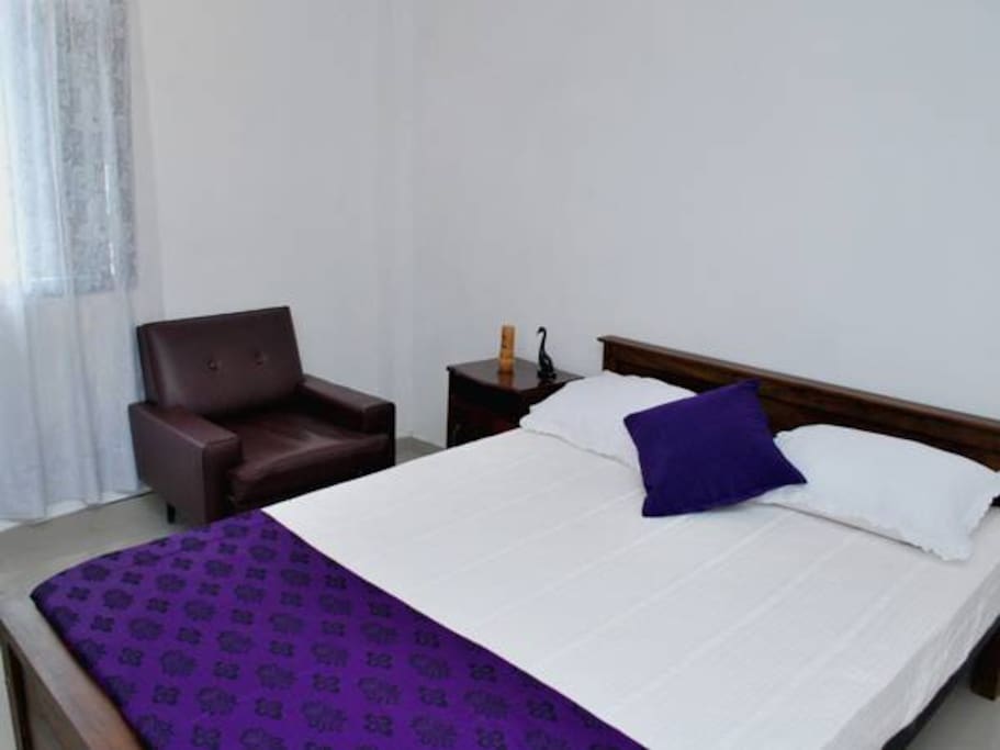 Bed room 1 with two sofa chairs.