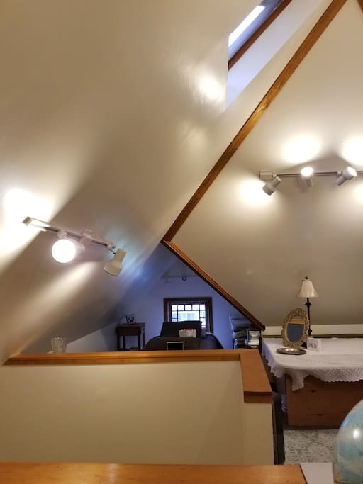 There is a skylight with high vaulted ceilings