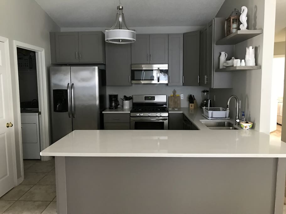 Newly renovated kitchen with Stainless appliances and large quartz counters