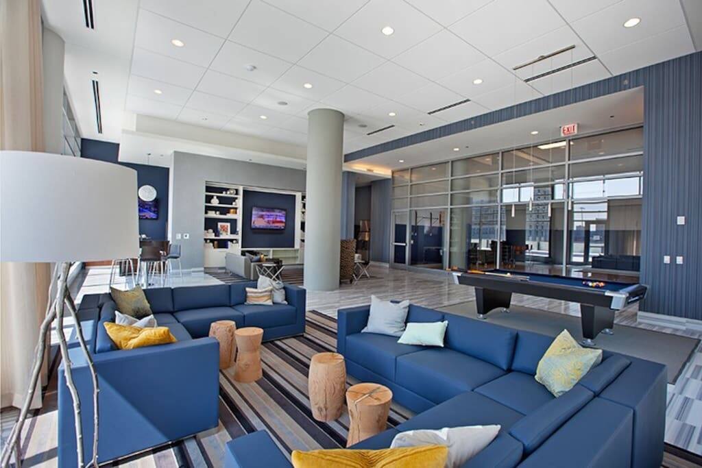 Community lounge area with couches and televisions. There is also a coffee & hot chocolate machine!