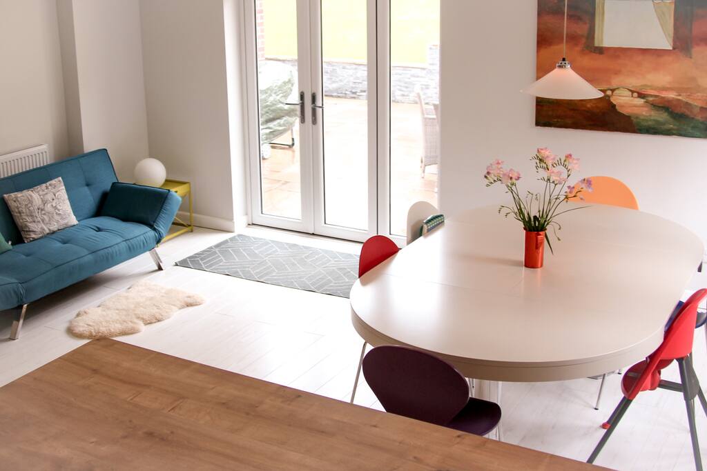 Kitchen table seats eight. We have a baby bjorn high chair and child seat. The kitchen doors open onto the front patio which is lovely when the sun is out. The kitchen sofa folds out to a double bed.